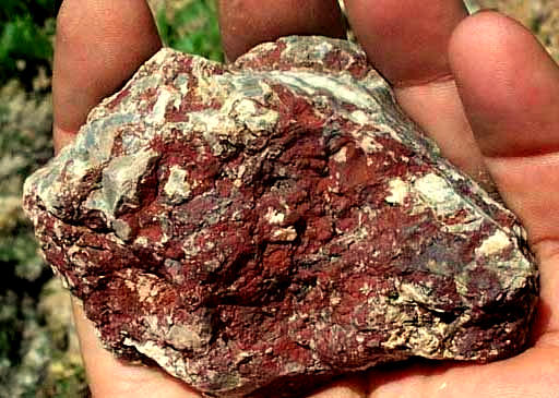 limestone rock coated with HgS, cinnabar, or mercury sulfide