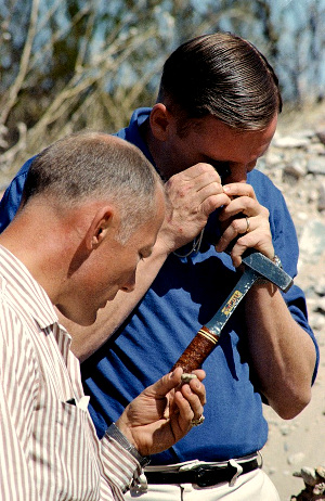 With hand lens and geology hammer, NASA astronauts practice for geology on the Moon; image courtesy NASA
