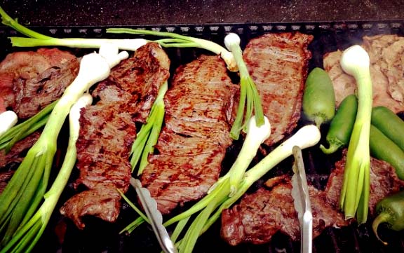 carne asada con cebollitas cambray, or grilled meat with Chambray onions, traditional summer food in Chihuahua; image courtesy of Proserpina Core